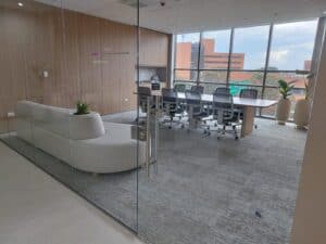 Sala de reuniones moderna con cristal y muebles minimalistas.