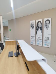 Recepción de clínica con fotos de médicos